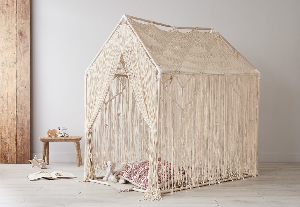 Macrame play house made from natural cotton styled with cushions and toys