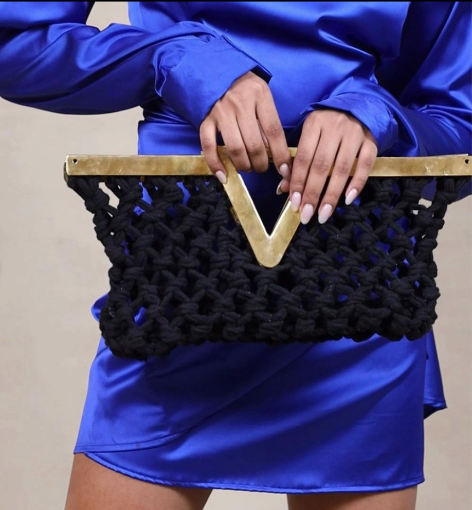 Macrame clutch bag in back with brass metal frame