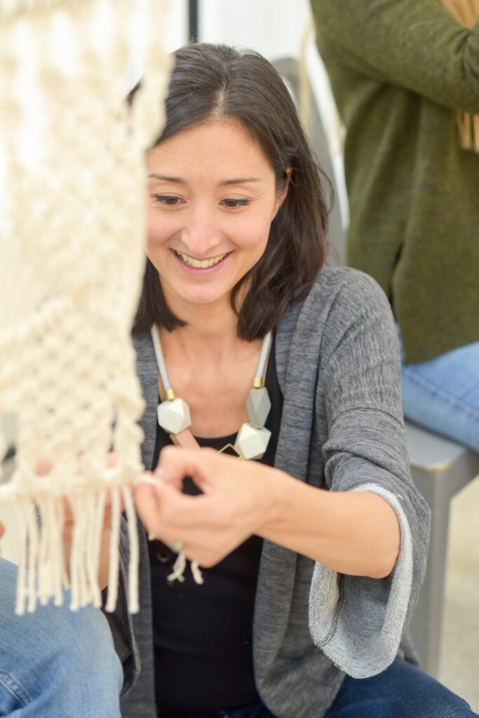 Isabella making a macrame early days at a macrame workshop in London